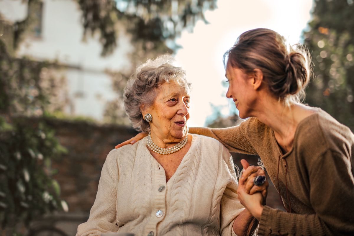 An older woman sharing a smile with a younger companion